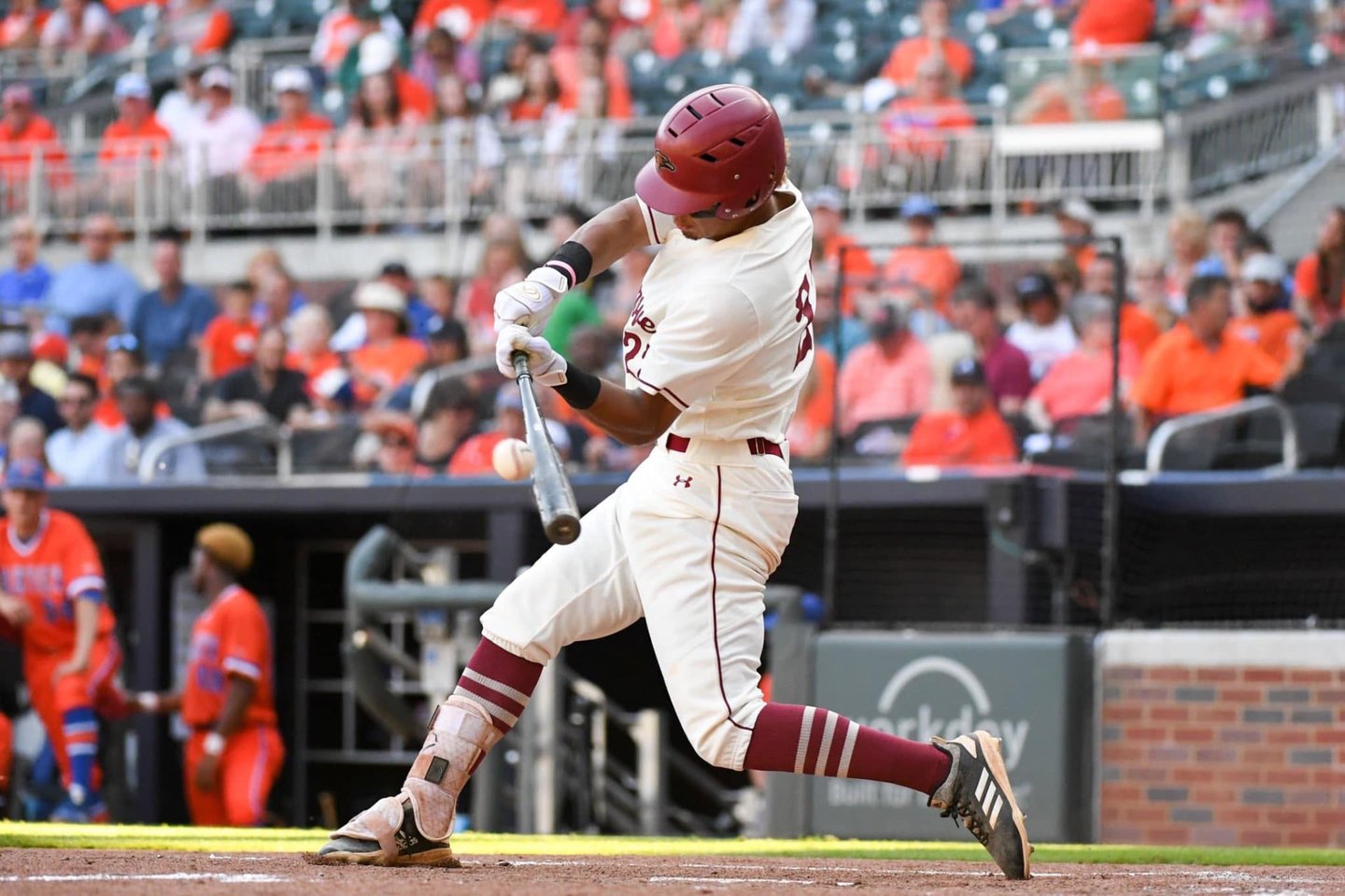 Hillgrove hitter making contact with the ball, bat extended through the zone.
